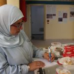 Woman writing list of display items