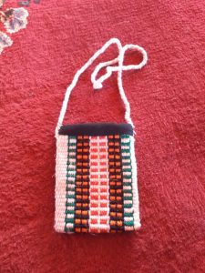 Woven textile bag on red carpet