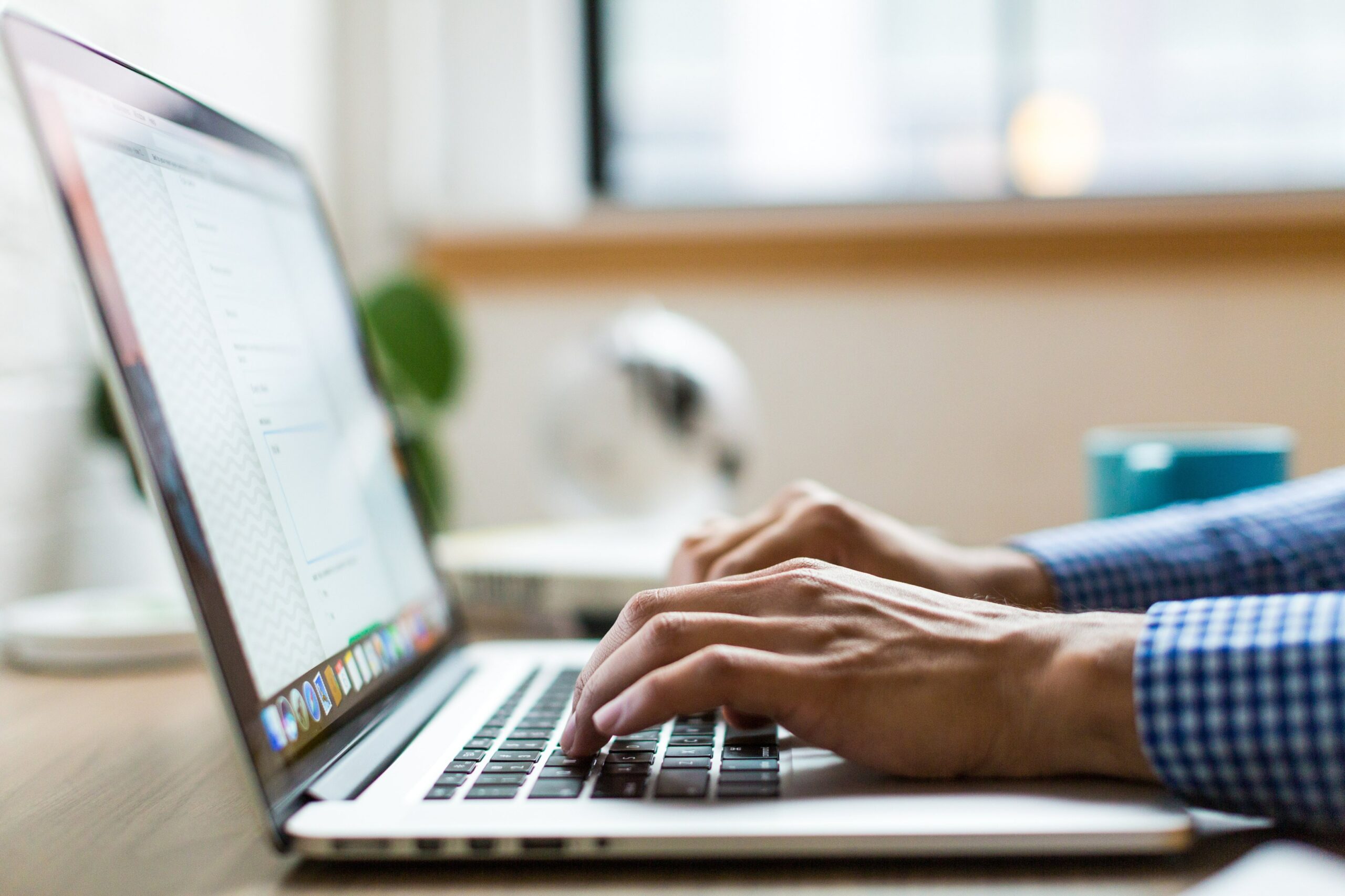 person typing on a laptop