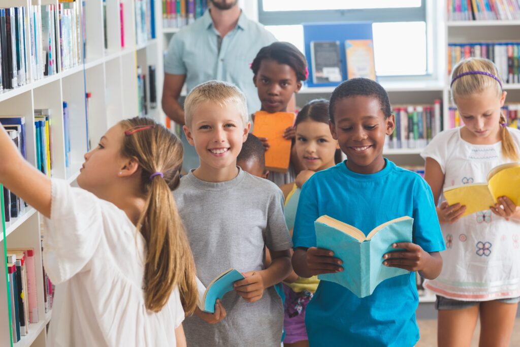 Girl removing book from bookshelf in library