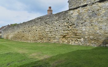 The north precinct wall at Glastonbury Abbey, with scars in the fabric suggesting the location of the former hostry (© Glastonbury Abbey; photograph: David Cousins)