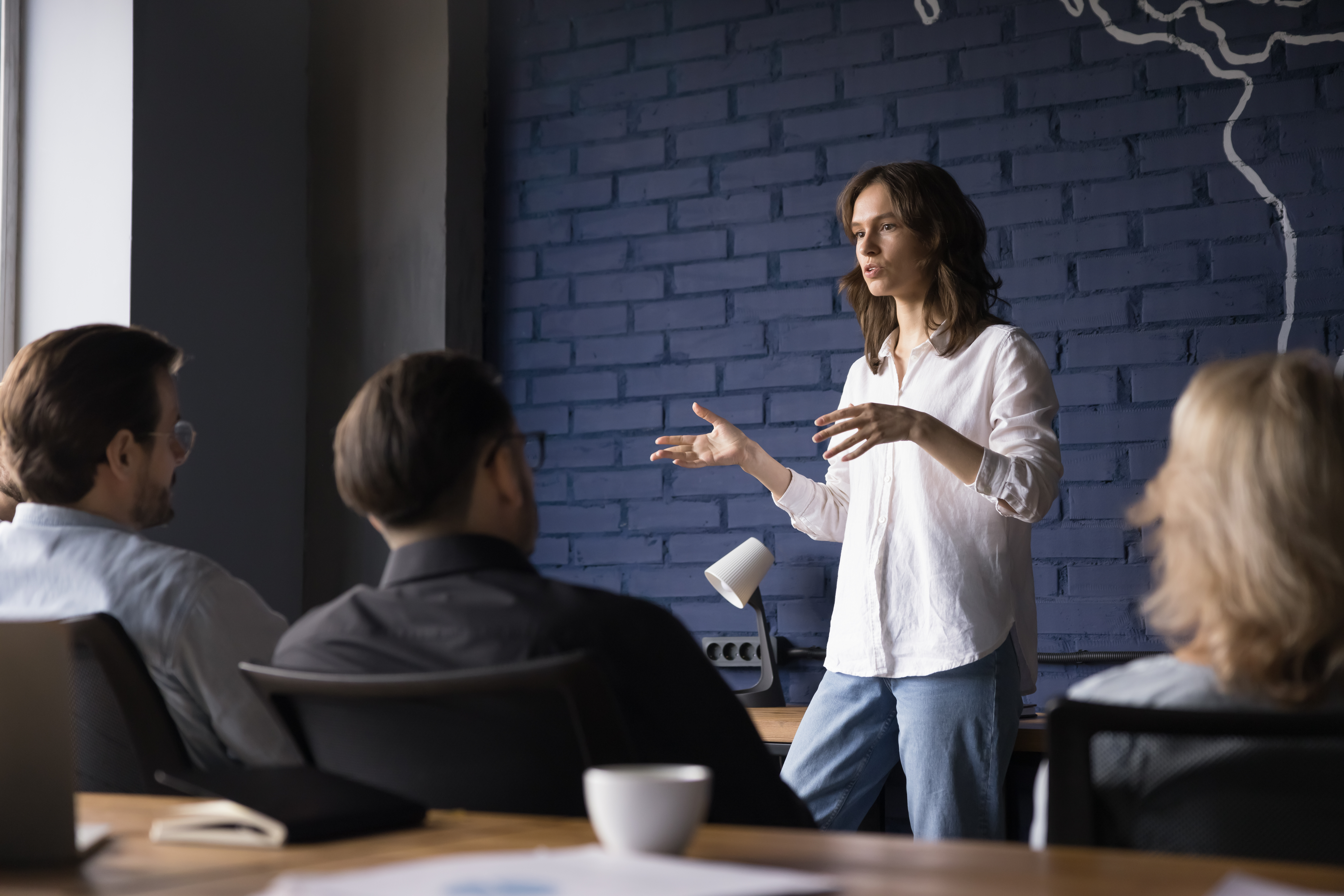 woman talking to a panel of people