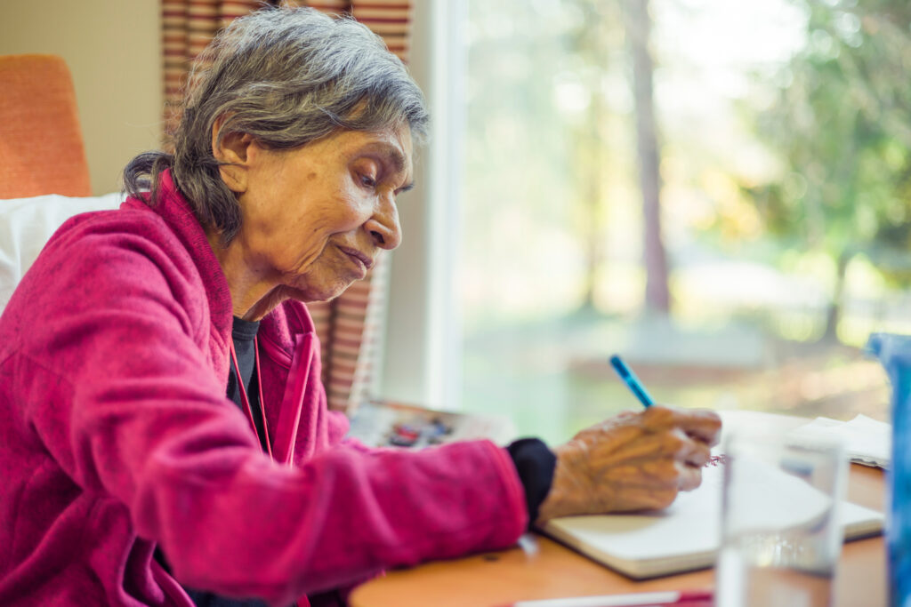 Older woman writing in journal