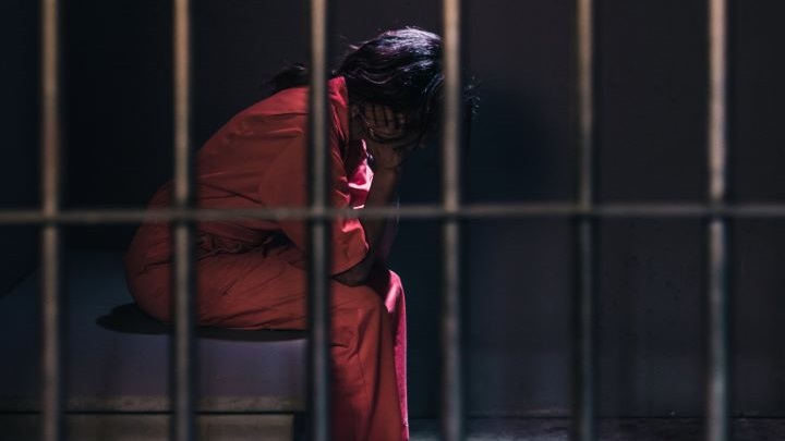 A somber scene capturing an individual's despair in confinement, focusing on the concept of loss of freedom