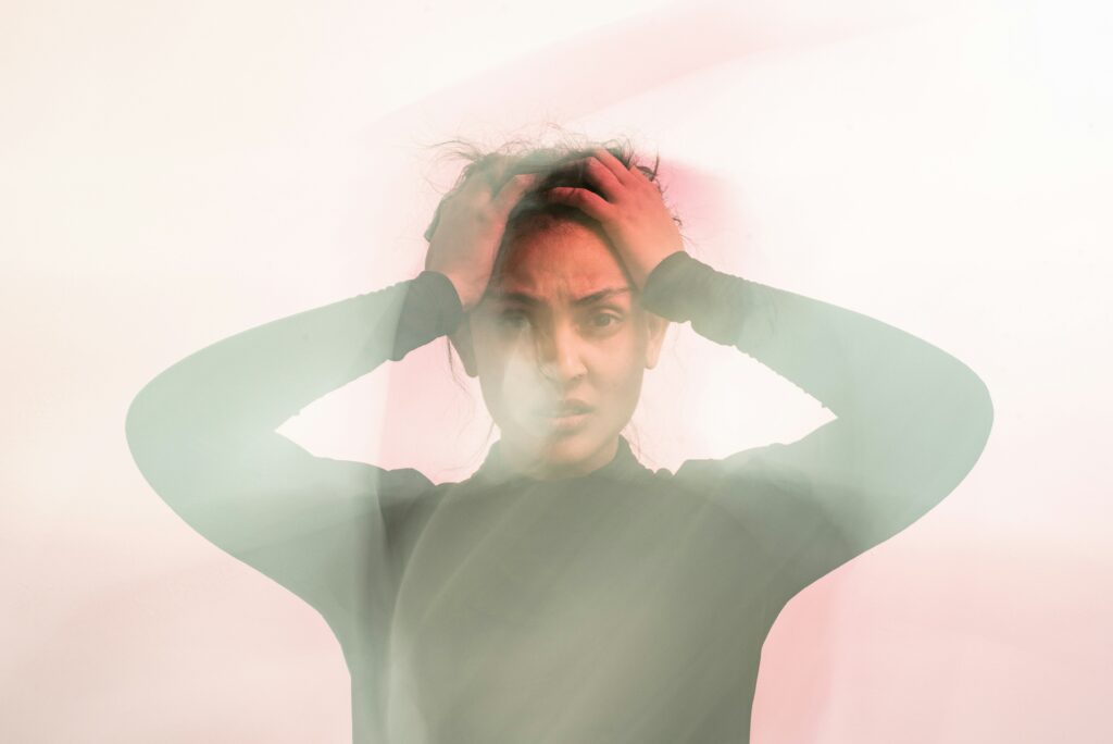 blurry-image-of-anxious-woman-holding-head
