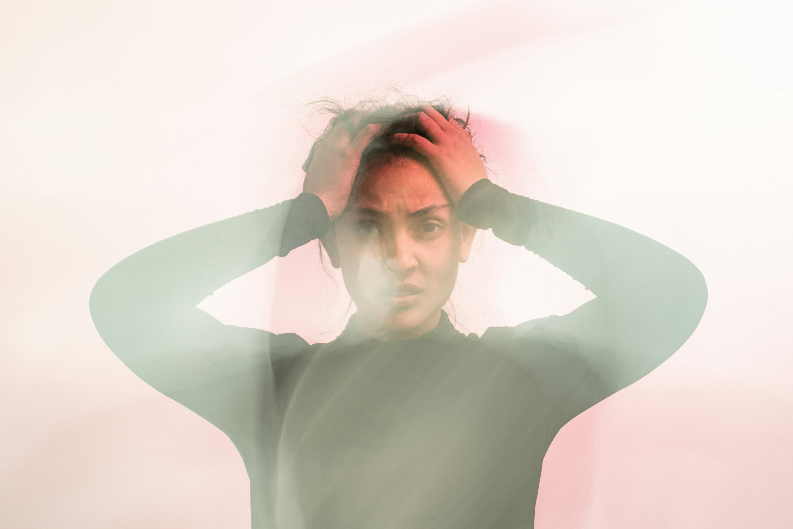 blurry-image-of-anxious-woman-holding-head